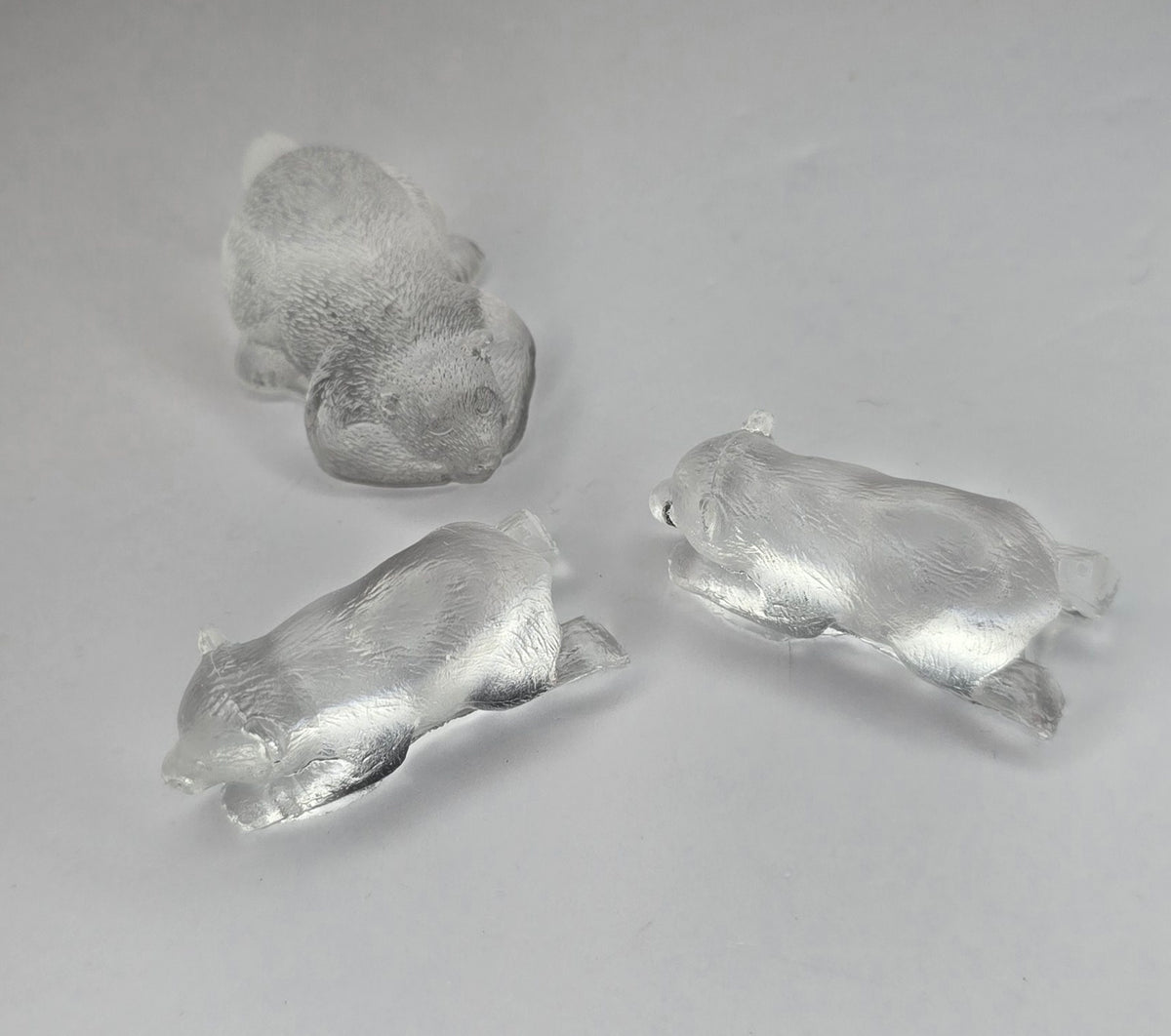 3 clear bear figurines